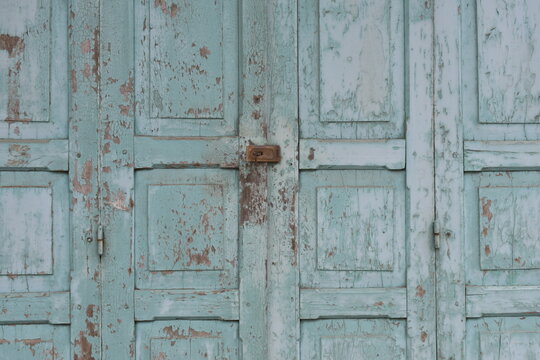 Vintage blue wooden door with rusty lock texture.