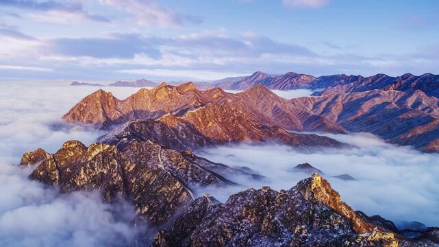 Timelapse of Beijing Jiankou Great Wall in winter, snow-covered peaks and clouds moving over rugged mountains.