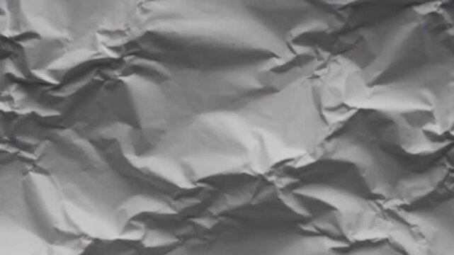 Crumpled white paper texture with many folds and wrinkles