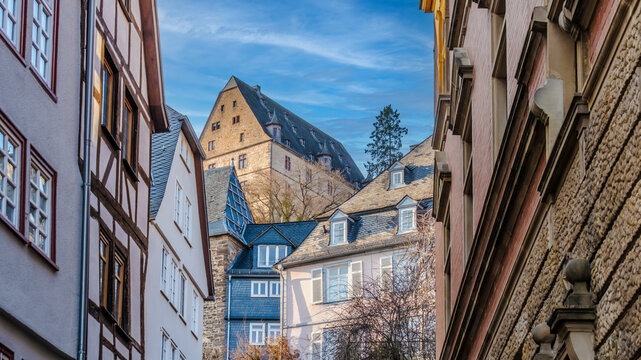 Marburg castle towering above historic half-timbered houses