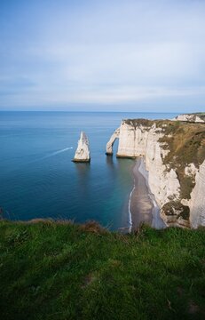 Scenic view on white chalk cliffs in Etretat, on the Alabaster Coast on the English Channel, Normandy, France. Famous travel destination. Landmark.Vertical banner