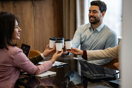Business colleagues toasting coffee cups at sheraton meeting