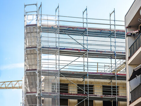 Scaffolding covering building during urban construction development