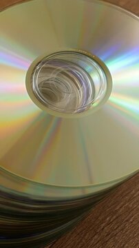 Stack of Compact Discs Reflecting Rainbow Light