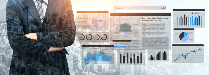 A businessman stands confidently in front of various digital dashboards showcasing data analytics, illustrating the importance of technology in modern business decision-making. Ledger © InfiniteFlow