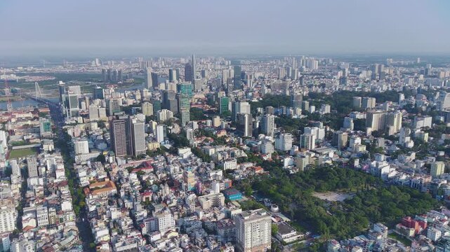 Cinematic drone tracking shot of Saigon downtown and Le Van Tam park with horizon and sky