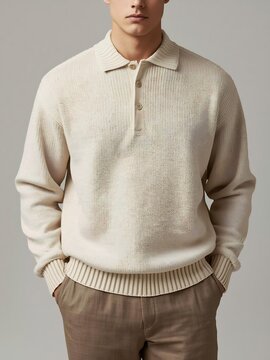 A man in a stylish beige knit polo shirt with a collar and buttoned placket, paired with brown trousers