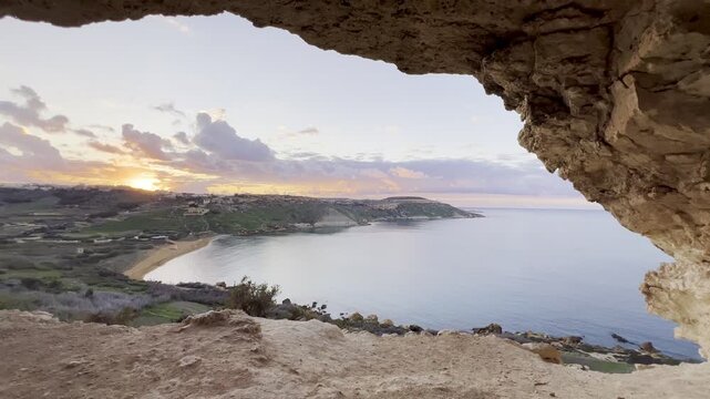 Tal mixta cave view of ramla bay at sunset