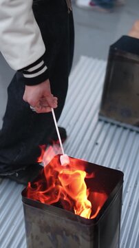 Roasting a Marshmallow over an Open Fire Outdoors