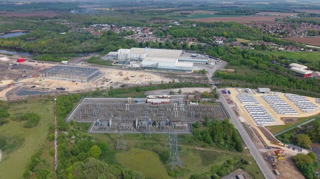 Aerial view of Ferrybridge Battery Energy Storage Systems with electrical substations and industrial infrastructure near green fields in Knottingley, England, United Kingdom.