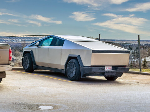 Calgary, Alberta, Canada. May 7, 2026. A Tesla Cybertruck parked in an outdoor lot, showing its stainless steel exterior and angular design.