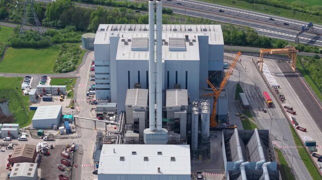 Aerial view of Enfinium 1 and 2 Ferrybridge waste-to-energy facility with its tall chimney and industrial structures in Knottingley, England, United Kingdom.