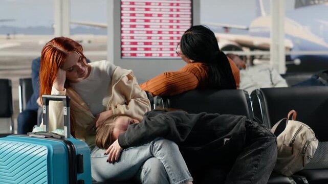 Resting on bench, cancelled flight and multiracial passengers in airport. Losing flight, airline overbooking and diverse group of tired tourists sleeping on chair, waiting for another plane