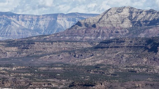 Zoom in aerial of Roan Plateau desert mountains in Mesa Colorado in spring with textured layers