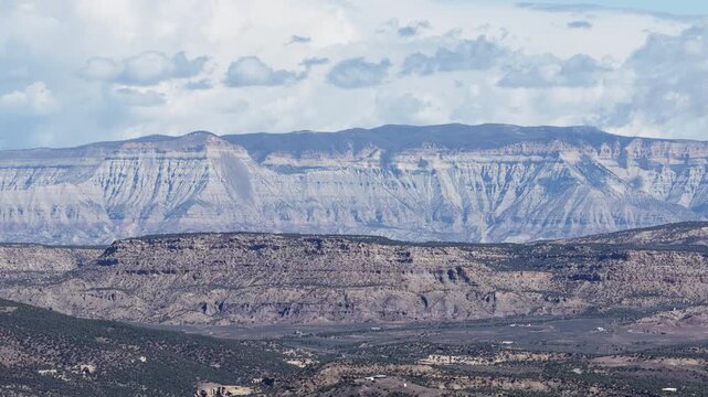 Zoom aerial of Roan Plateau Book Cliffs in Parachute Colorado with dramatic sky