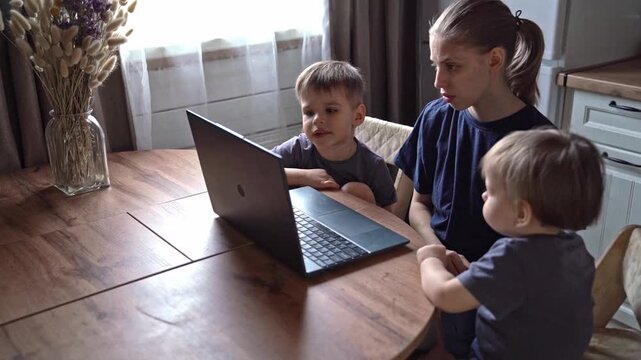 Maternal teaching moment. Mother imparts wisdom through technology. Caucasian mother shares knowledge with sons respectfully. Gentle maternal figure instructs children using modern devices kindly