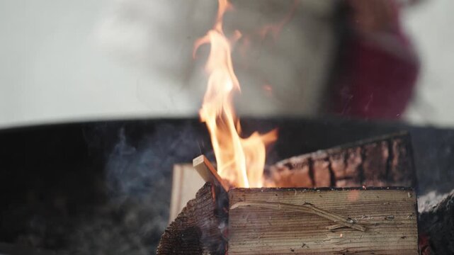 Burning Firewood with Flames and Smoke in Outdoor Setting