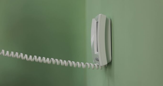 Man answering intercom call at home, closeup