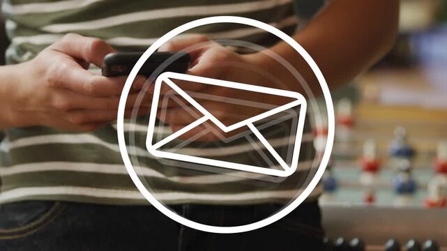 Man holding phone tapping as envelope icon animating, arm reaching checking messages near foosball