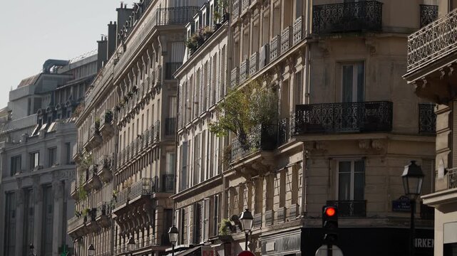 Establishing shot of a classic Parisian street featuring traditional architecture balconies and street lamps The scene captures the essence of a romantic neighborhood in Paris France highlighting its 