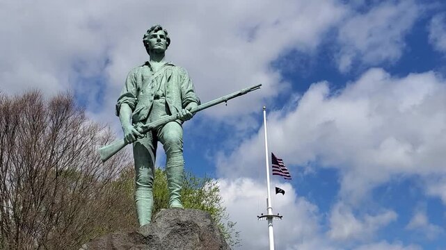 The famous statue of the Revolutionary War minuteman stands tall on Lexington Battle Green. It is here the Revolutionary War started in 1775. America 250th Birthday. Lexington, MA on May 07, 2026