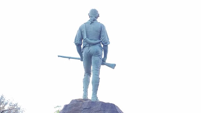 The famous statue of the Revolutionary War minuteman stands tall on Lexington Battle Green. It is here the Revolutionary War started in 1775. America 250th Birthday. Lexington, MA on May 07, 2026