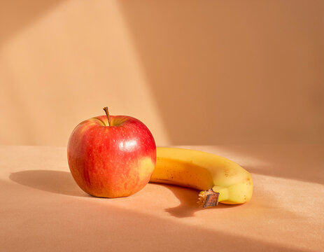 apple and banana on minimal background, realistic fruit composition