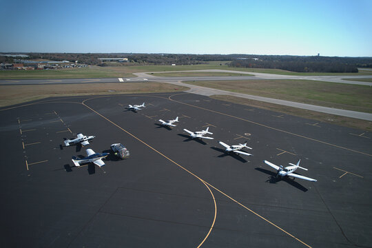 Bird's eye view of light aircraft and hangars at a sunny Virginia airport