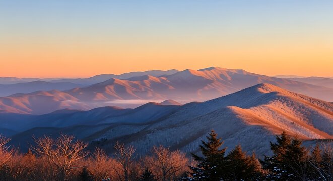 Snowy Mountain Ridges Glowing at Sunrise in Misty Wilderness Landscape