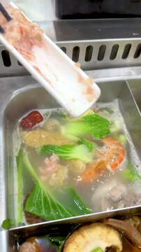 Cooking Pork Paste in a Boiling Thai Shabu Shabu Hot Pot