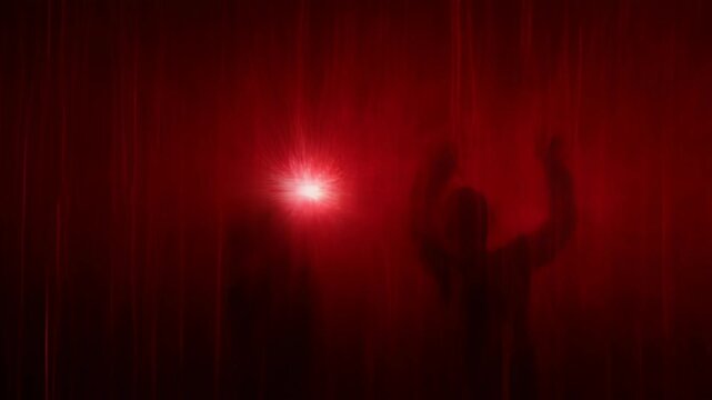 Red black grunge horror creepy shadow silhouette behind red curtain with dark eerie stage mood and black silhouette in dark abstract scene creating eerie tension and fear