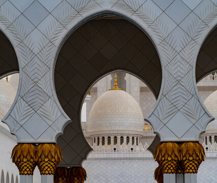View of the ornate white marble arches and floral patterns of the Sheikh Zayed Grand Mosque Abu Dhabi, Abu Dhabi, United Arab Emirates.