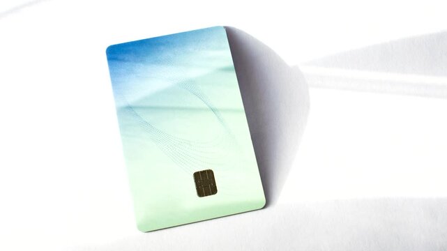 Credit card on a white surface, highlighting simplicity and elegance in financial transactions. Credit card on a white surface, emphasizing simplicity and versatility in transactions.