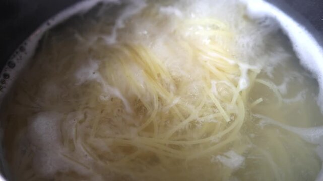 Pasta Boiling In Water Inside A Household Pot