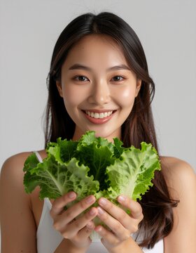Radiant Embrace: A woman's joyful gaze meets the viewer, tenderly holding fresh lettuce leaves, a symbol of natural nourishment and vitality. 