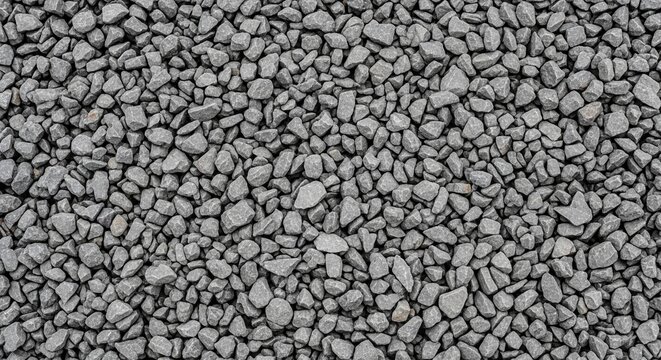 Seamless texture of grey gravel, close up of small irregularly shaped crushed stones for construction, landscaping, and abstract backgrounds