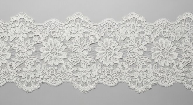 Delicate white floral lace trim with scalloped edges and intricate pattern on a neutral background