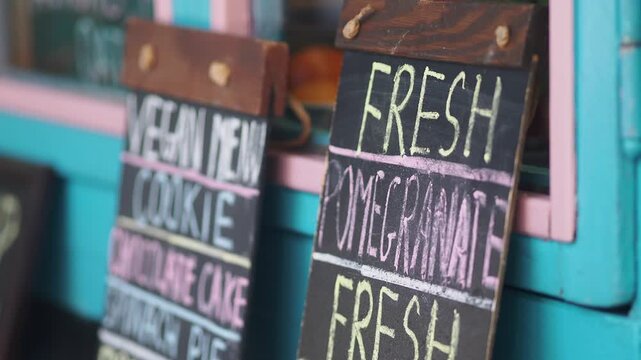 Fresh pomegranate sign outside a colorful cafe