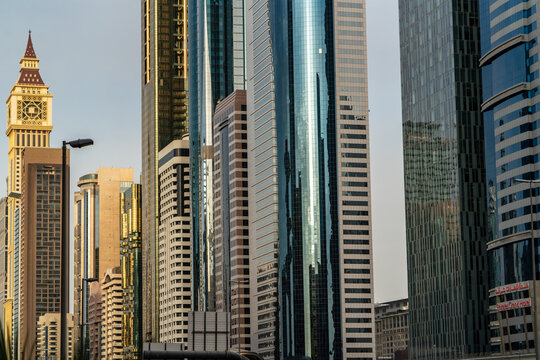 View of modern skyscrapers and the Al Yaqoub Tower along Sheikh Zayed Road under a clear sky in Dubai, Dubai, United Arab Emirates.