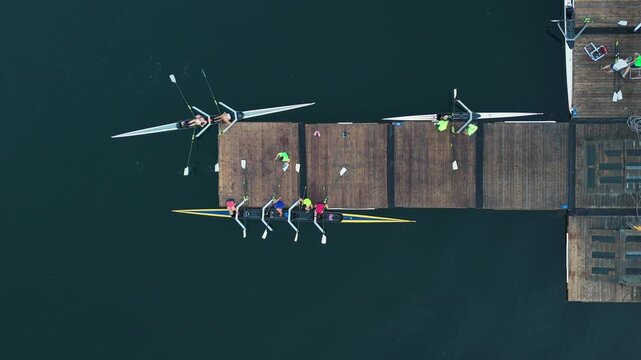 Top View Rowing Team Men And Women Finishing Practice Halifax Nova Scotia Canada Lifting Boat And Oars Walking To Storage Area Sport Training Scene 4K