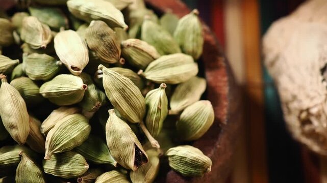 Cardamom pods and dried ginger in spice market display