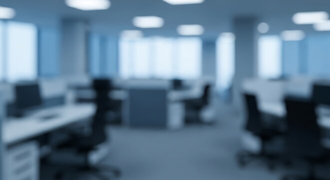 Modern office interior with cubicles and chairs, blurred for a soft, abstract effect.