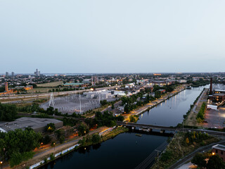 Fototapeta premium Montreal skyline and Lachine Canal at blue hour with illuminated cityscape and urban waterfront, Canada. g.