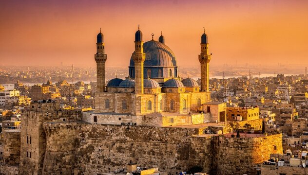 Blue domed mosque with minarets stands above a historic stone citadel at sunset for travel editorial, Middle Eastern architectural campaign and cultural heritage visuals