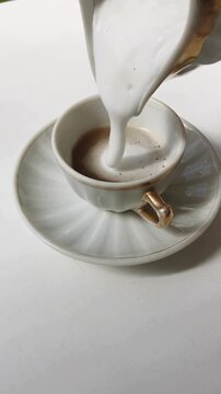 Pouring Creamer Milk into Cup Creating Aesthetic Swirl, Cozy Cafe Beverage and Minimal Drink Concept