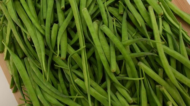 Fresh cluster beans rotating. Gavar beans. Cyamopsis tetragonoloba.