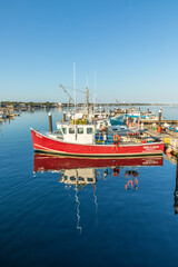 Obraz premium fishermens boats and private yachts anchor at the pier in Provincetown