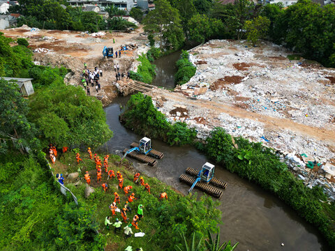 Heavy Machinery and Field Workers Cleaning Polluted River and Excavating Trash in Urban Area