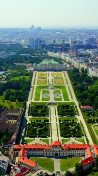 Vertical video. Vienna, Austria. Belvedere Palace, the baroque palace complex with formal French gardens, Drone footage over the historic cityscape under clear summer sky. Drone footage. Rich colors