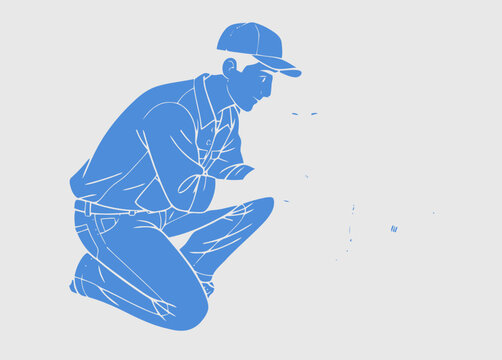 Man wearing cap and jeans crouching down to look at something on the ground